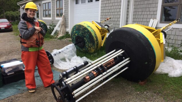 Technician standing next to LOBO buoy ready for deployment