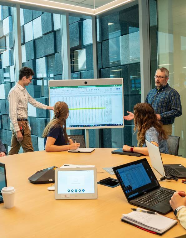 two men giving a presentation on a large screen