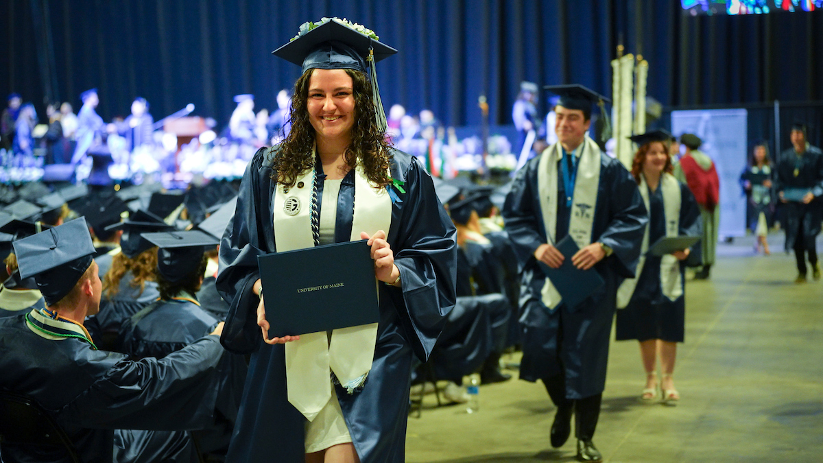 A photo of a student with her diploma