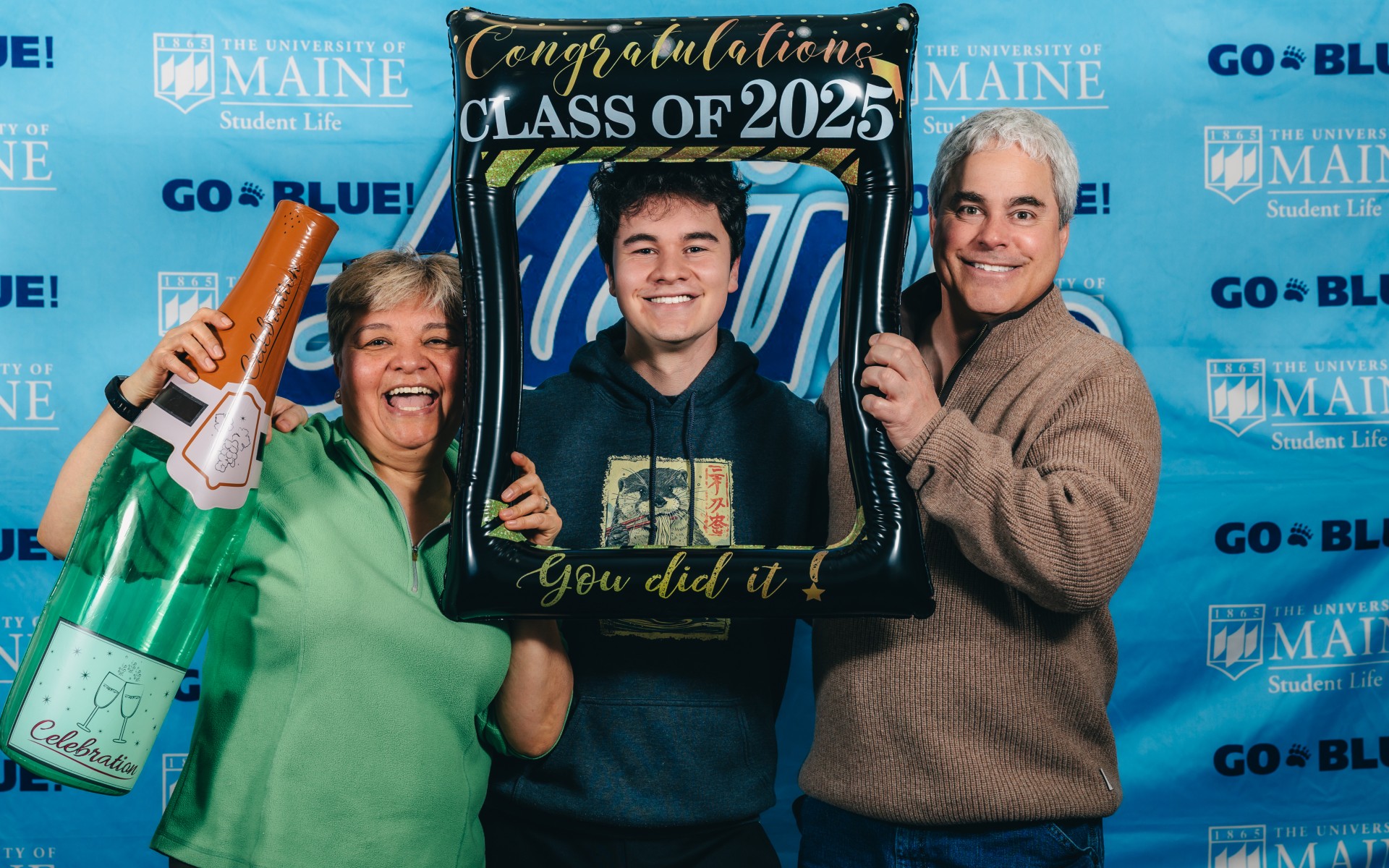 A photo of a graduate with his parents