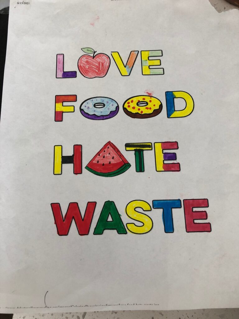 A student poster reading "Love Food Hate Waste"