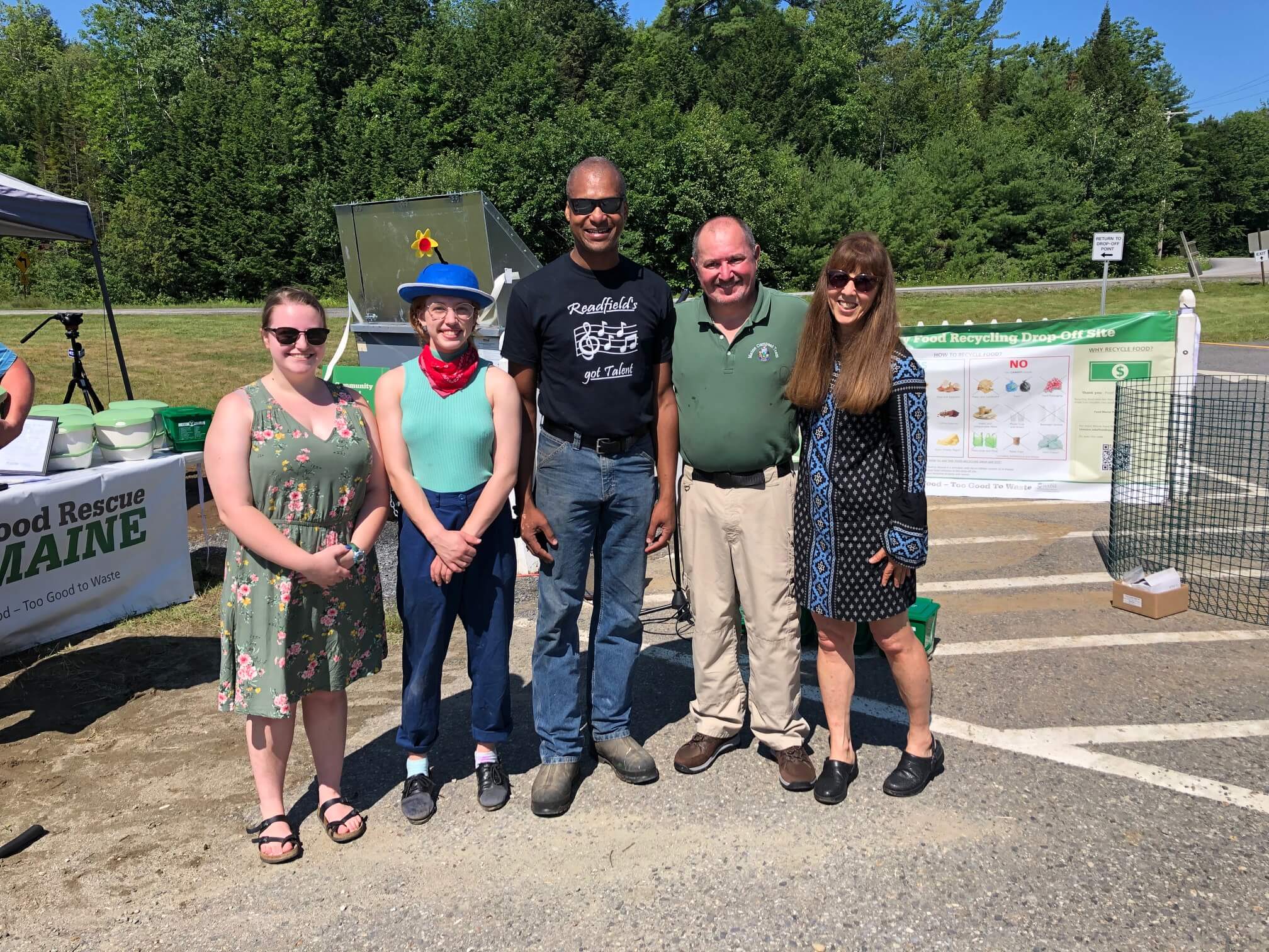 Four people lined up, smiling