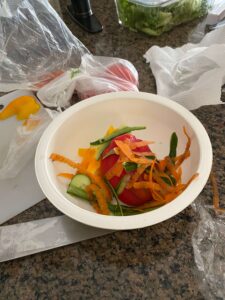 photo of food scraps from a salad in a mixing bowl.