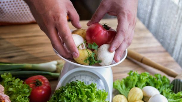 Photo of a person measuring food on a scale