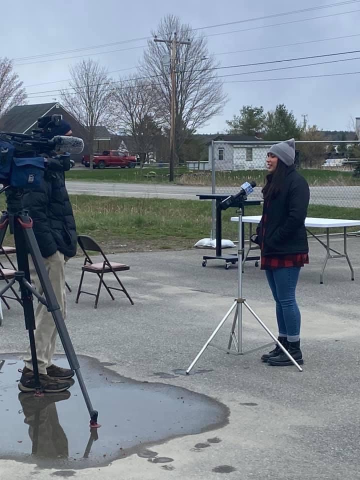 Photo of FRM intern, Hannah Crayton, speaking into a microphone for a press release