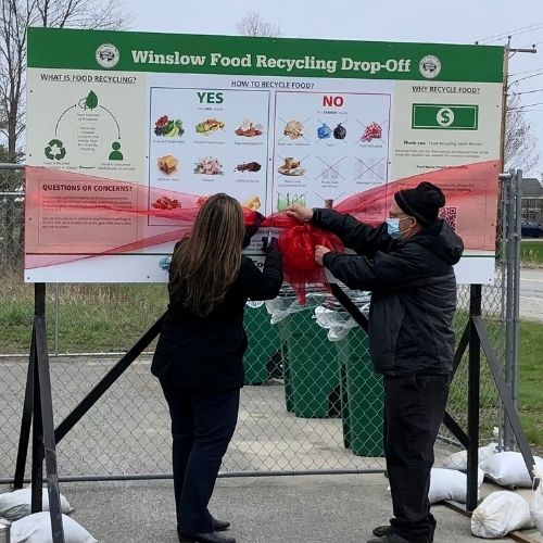 photo of two people cutting the ribbon at Winslow town food recyclinglaunch