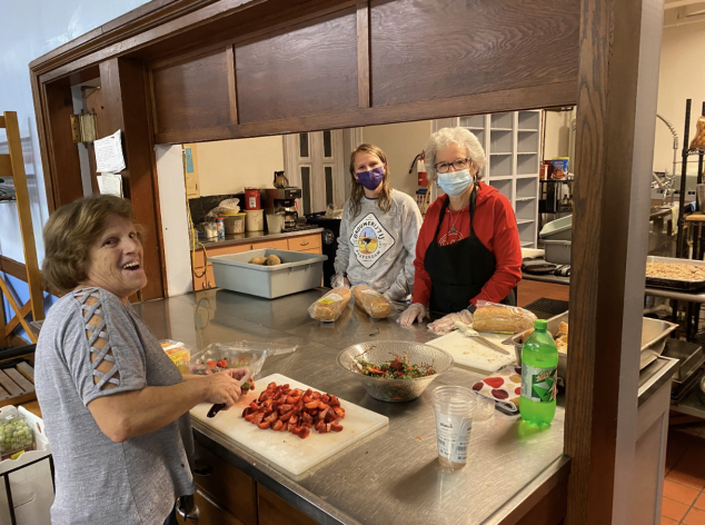 Three people preparing food