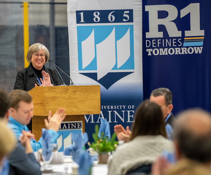 president ferrini-mundy with umaine and R1 banners