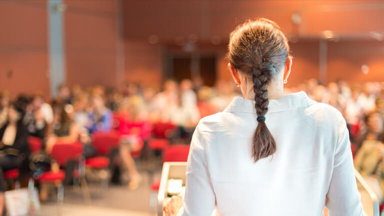 view of full lecture hall from behind professor