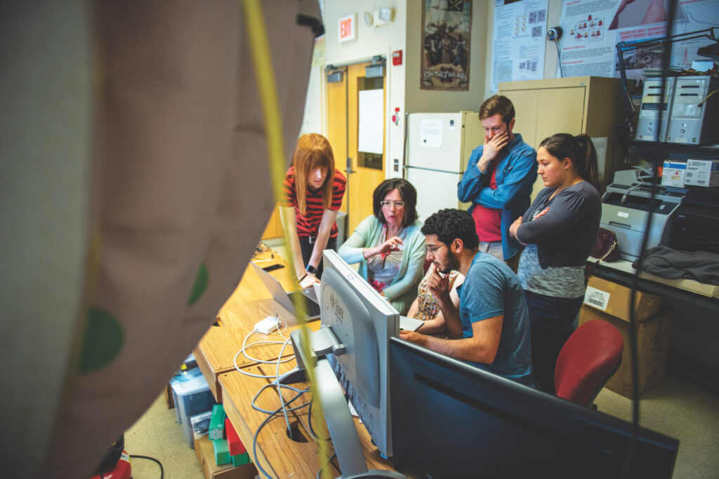 professor and students working in psychology lab