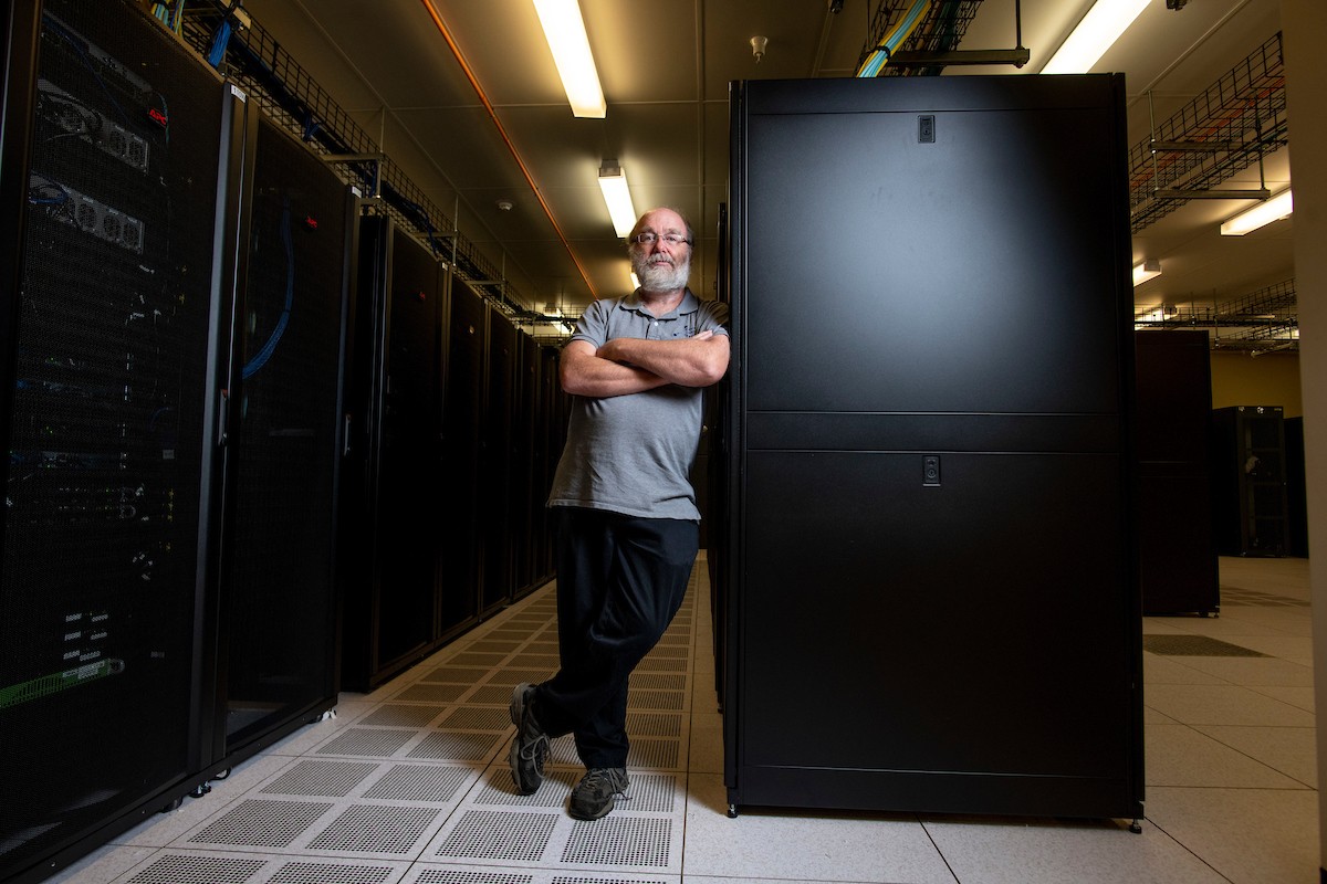 person leaning against a super computer