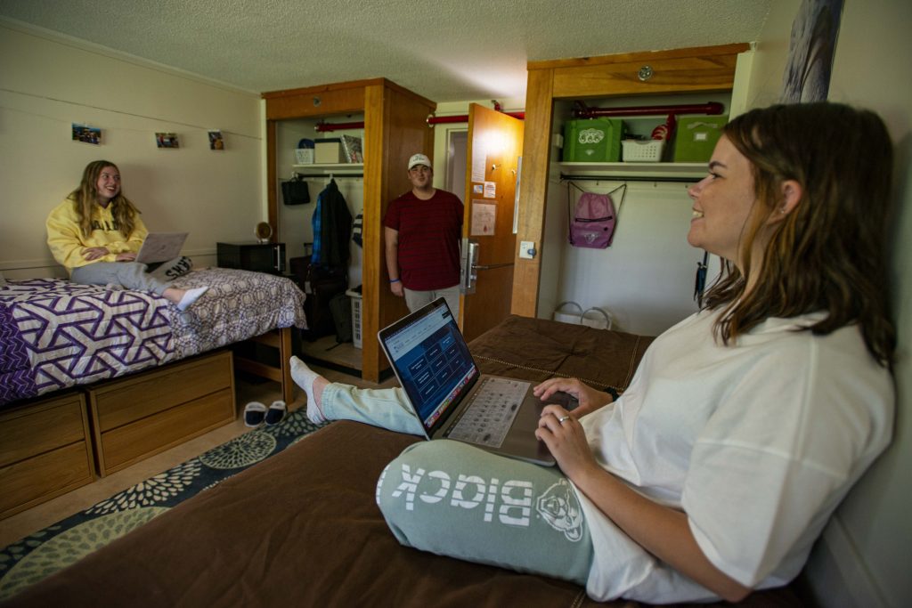 Smiling students in Penobscot Hall double room