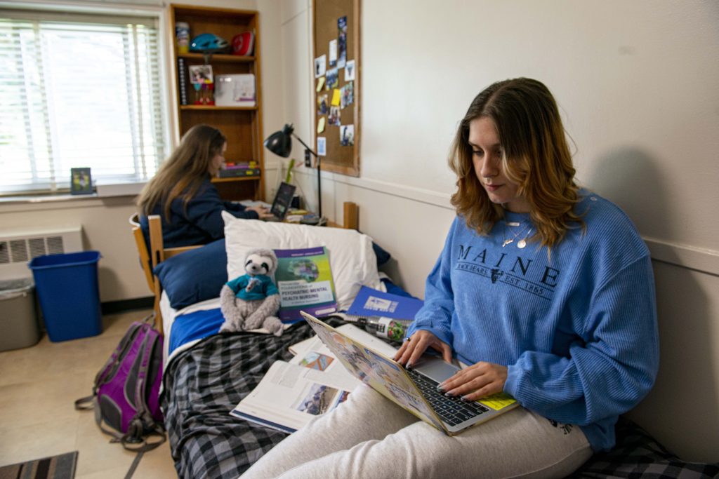Two female students studying in Penosbscot Hall double room