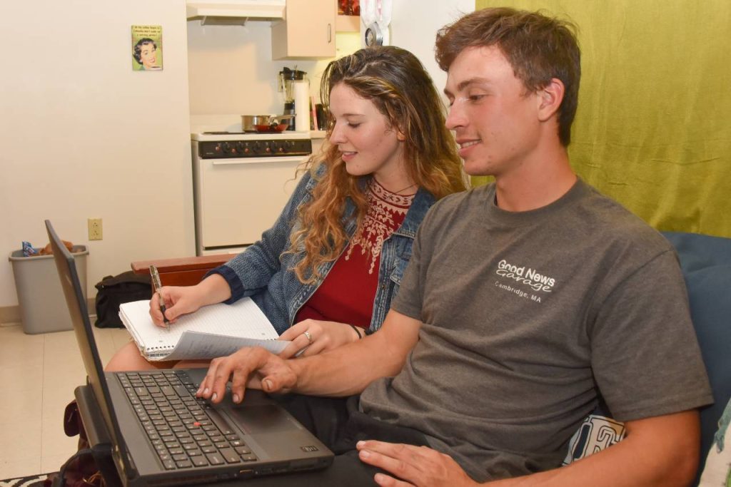 A male and female student studying on a couch in Patch Hall
