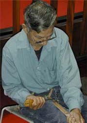 Donald Sanipass working with crooked knife