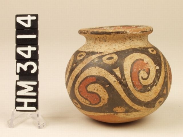 Miniature polychrome ceramic jar. Designs of "Y" motifs and abstract claws within spirals.