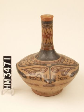 Ceramic bottle with wide base and long, narrow neck decorated with stingray motif.