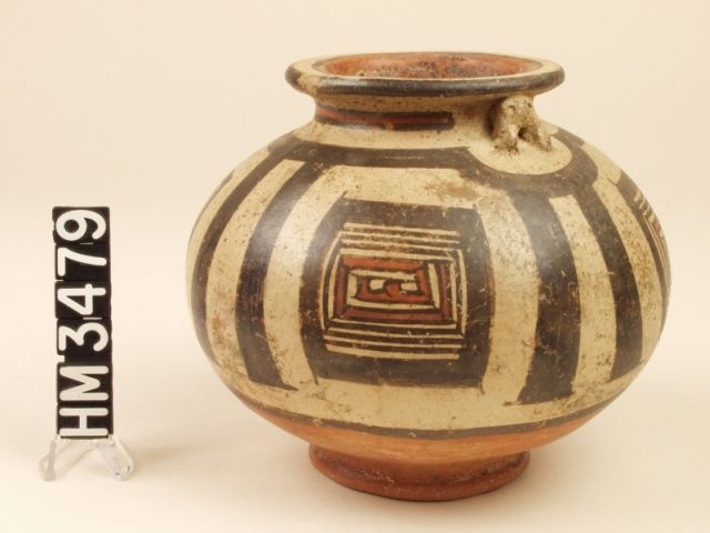 Polychrome ceramic jar with geometrical kennings in the form of claws that represent frog legs. Applique frog effigies perch below the rim of the jar.