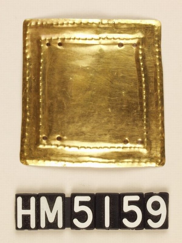 Gold ornament in form of rectangle with simple nested rectangular lines.
