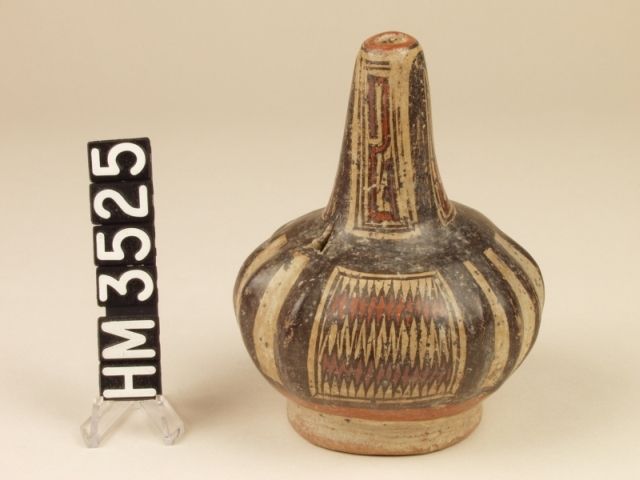 Miniature polychrome ceramic bottle. A narrow-mouthed vessel modeled after a gourd. Red bands with jagged edges on the side panels indicate the boa motif.