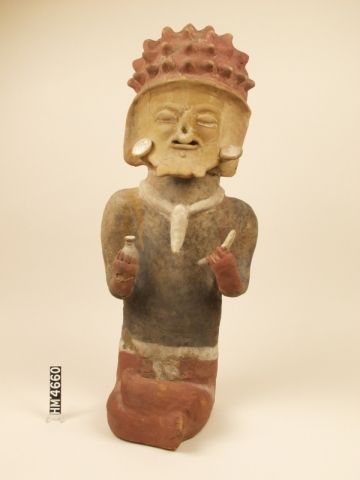 Image of seated ceramic figure with headdress, ear spools, septum ring, and necklace.