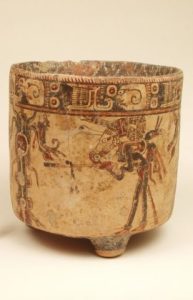 An intricately painted cylindrical vase.