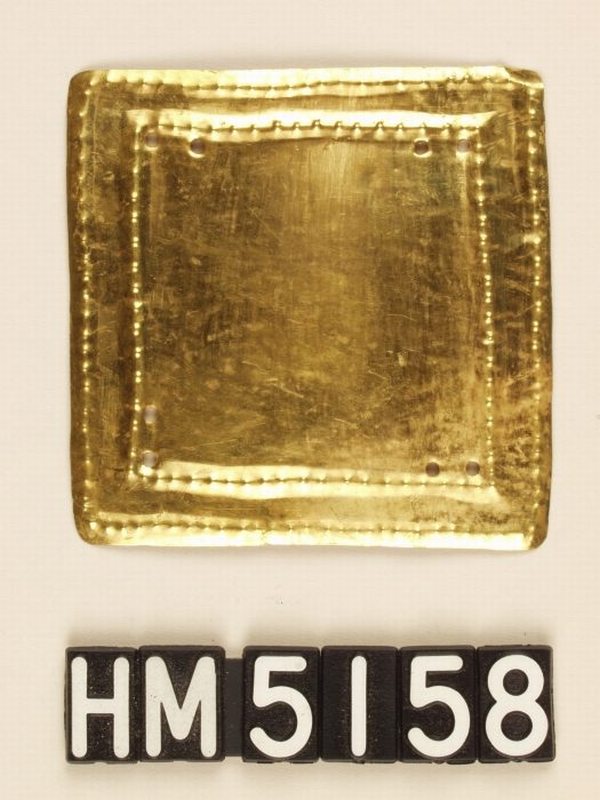 Gold ornament in form of rectangle with simple nested rectangular lines.