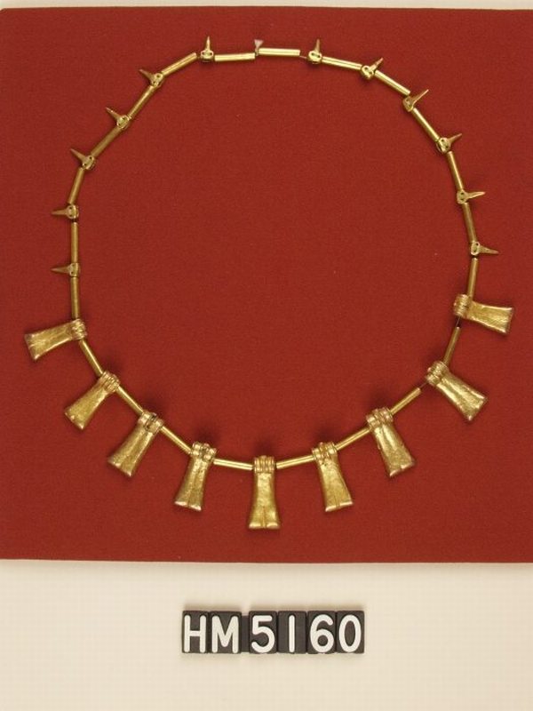 Image of necklace made with gold beads shaped as tubes, shaped as small pointed elements, and shaped as finger bones.