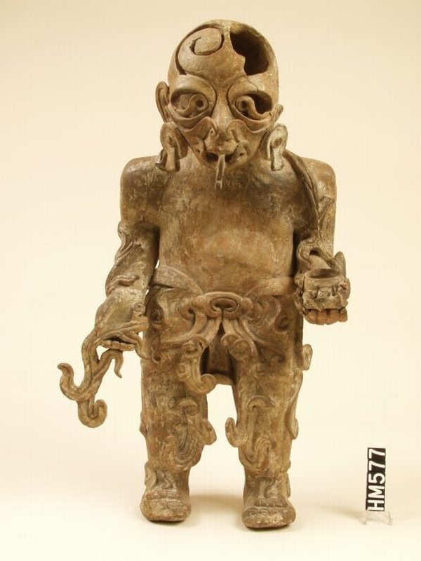 Ceramic figure, intricate, with a skull for a face.