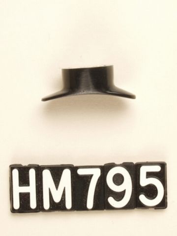 Small obsidian lip plug with flared base.