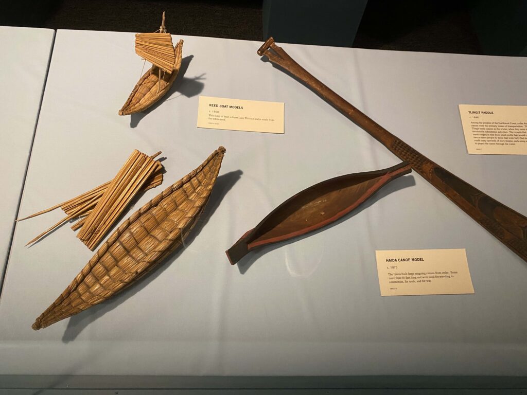 Image of small boat models in a museum exhibit.