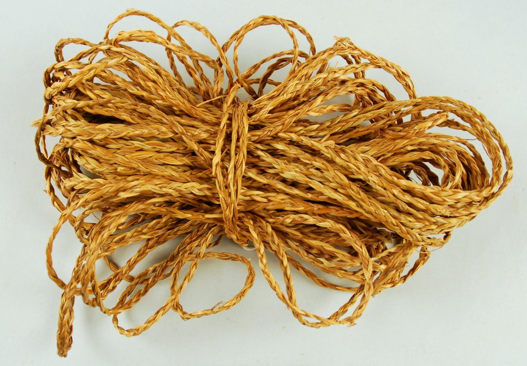 Loosely bundled string of braided grass.