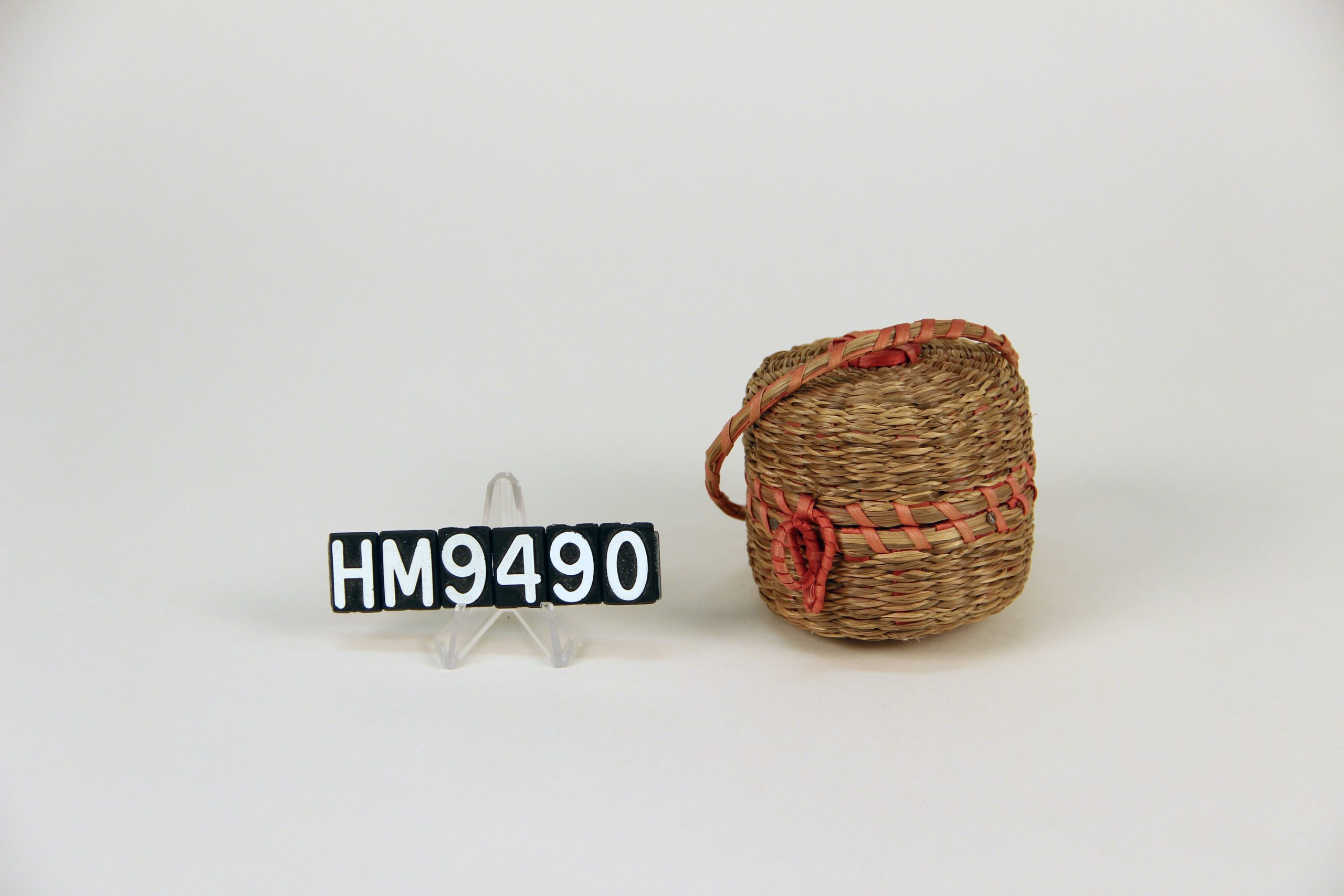 Image of small, round basket that comes apart int he center.