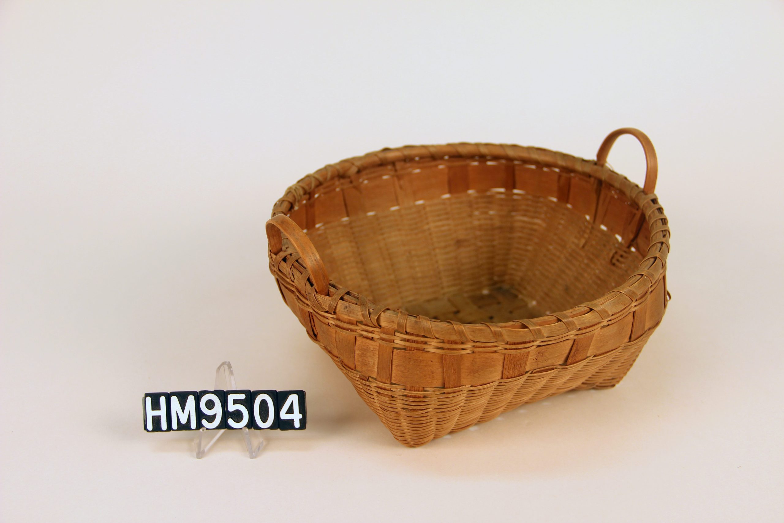 Image of a basket with square bottom and wider round rim with two handles.