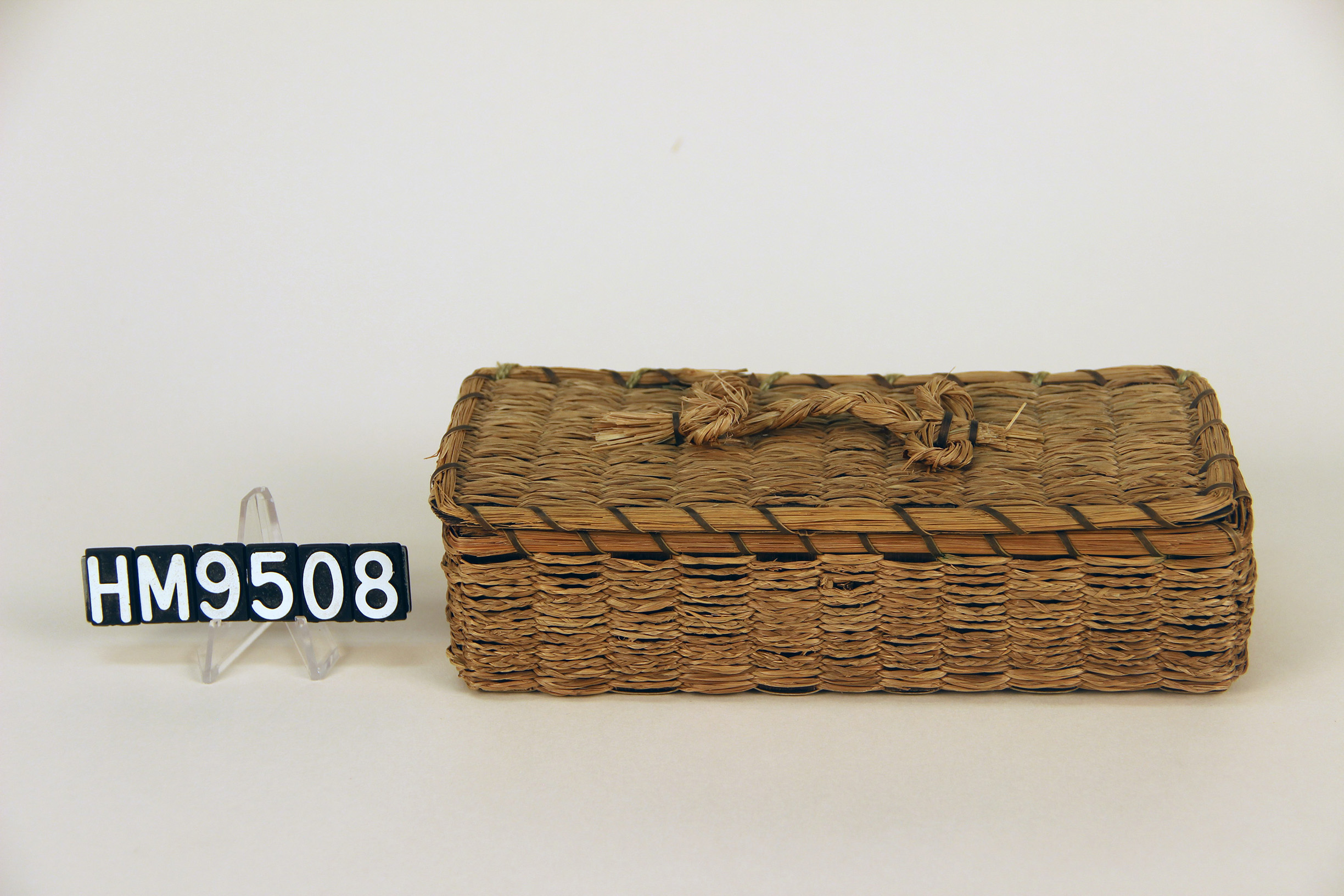 Image of rectangular basket woven with sweetgrass braids.