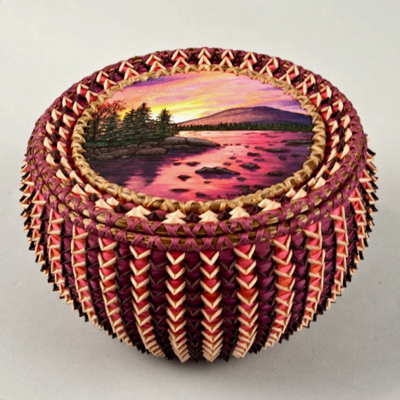 Image of intricate basket with beautiful landscape painted on cover.