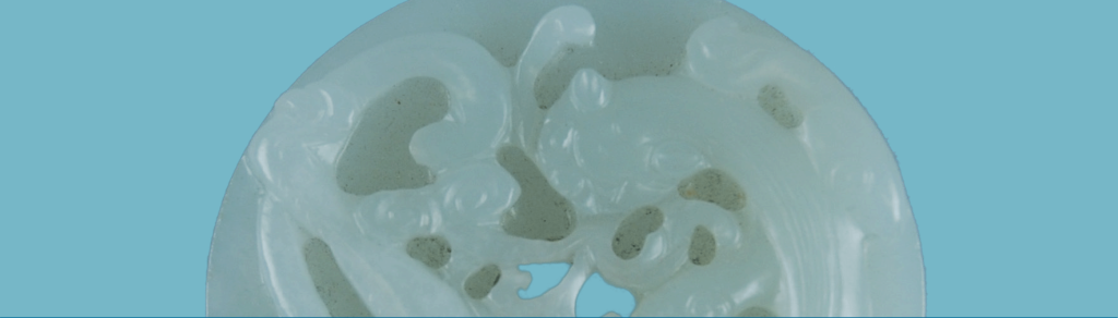Closeup image of carved pale green jade.