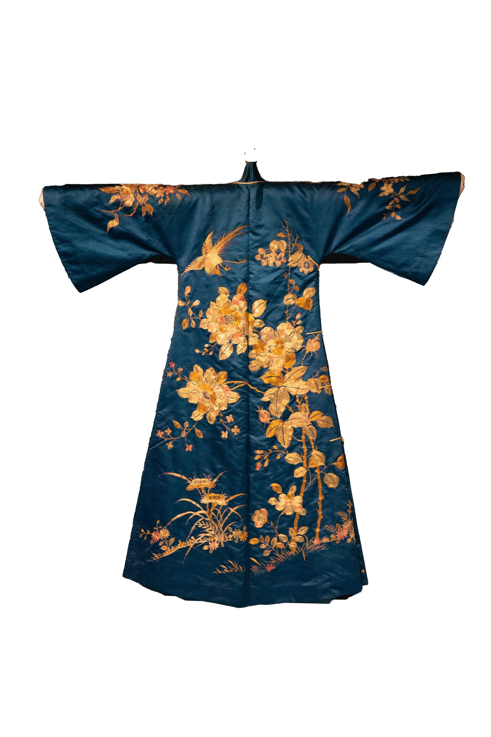 Image of dress in dark teal with golden floral embroidery, a high neckline, and long, wide sleeves.