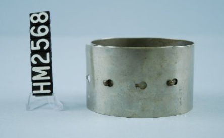 Image of a simple silver bracelet made of a wide band with holes allowing it to be different sizes.