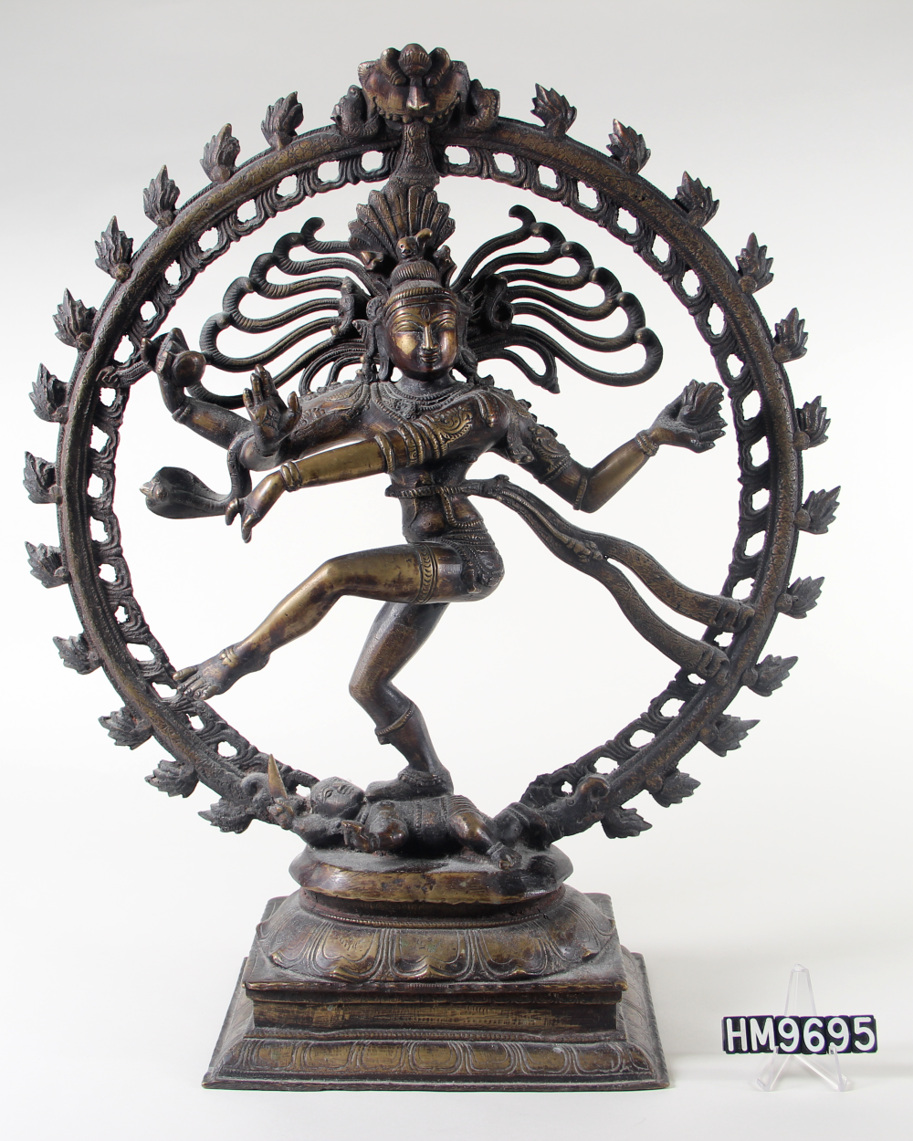 Image of a cast bronze statue of Shiva with four arms, dancing, surrounded by flames.