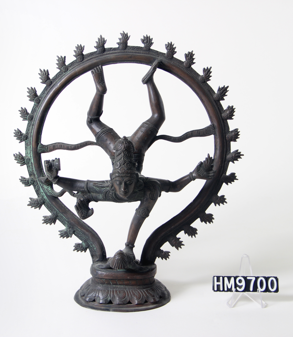 Cast bronze sculpture of deity - appears to be falling, head-first, with one hand on a small being below them.