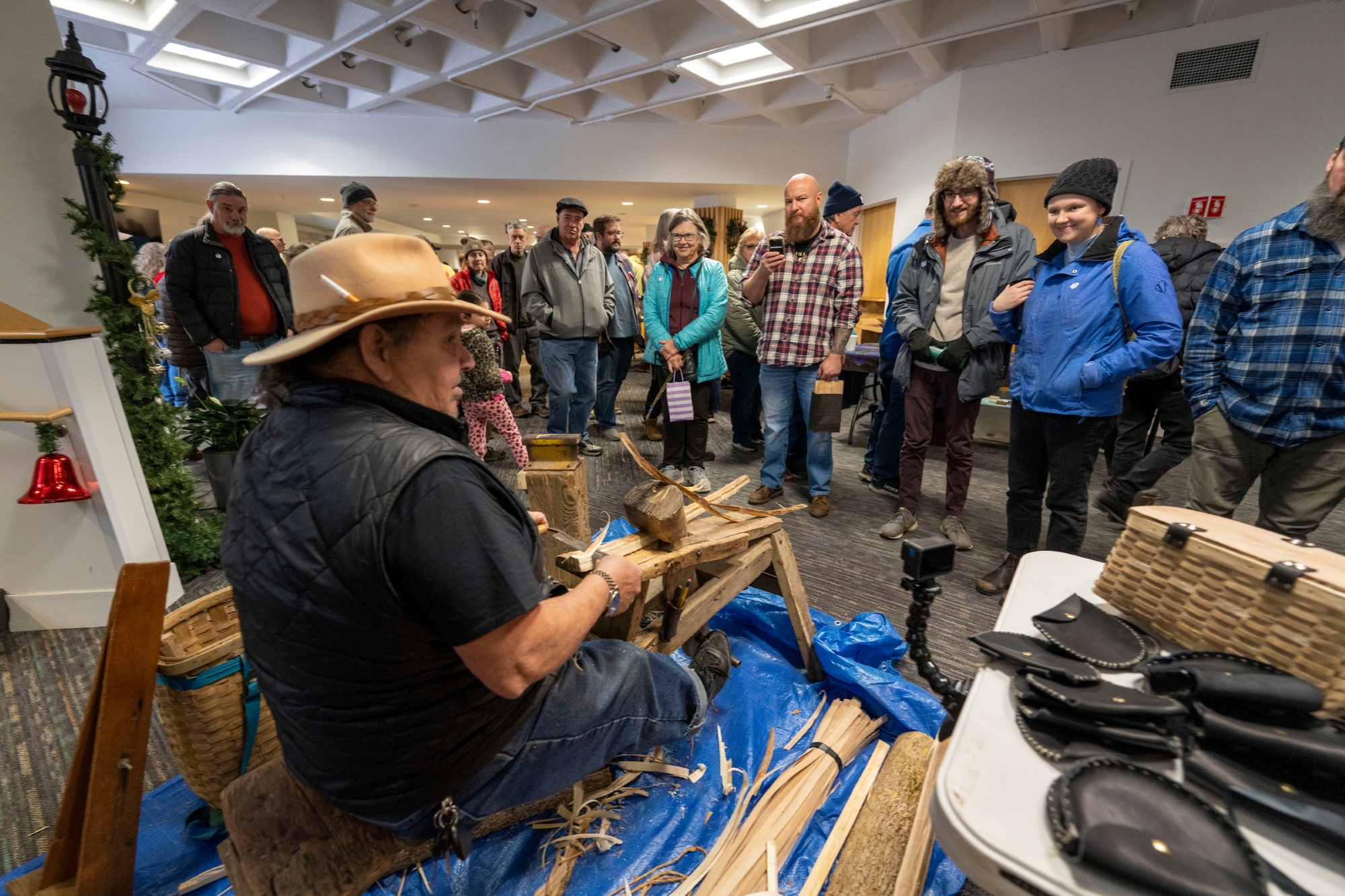 A man does a demonstration for a crowd.