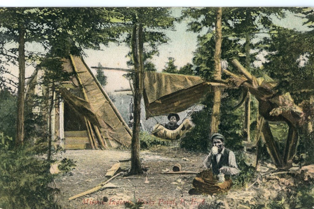 Colorized image of a man and child in a wooded area with a large canvas tepee. The man is seated and holds two small baskets with porcupine curls. He sits amongst basketmaking materials. The boy sits in a hammock.