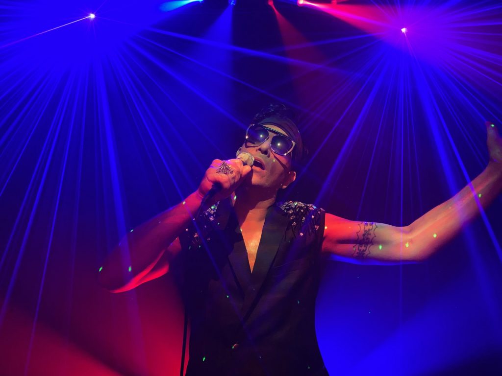 Firefly performing with theatrical lighting.