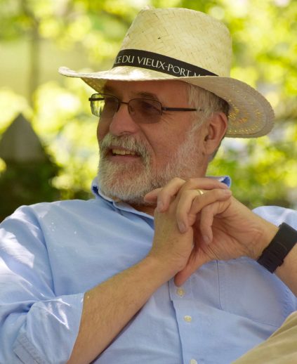 Image of Caucasian man outside wearing brimmed hat and glasses.
