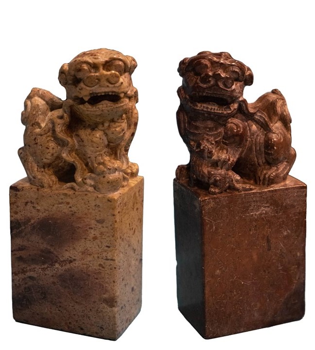 Image of two carved stone figures of Chinese dogs.