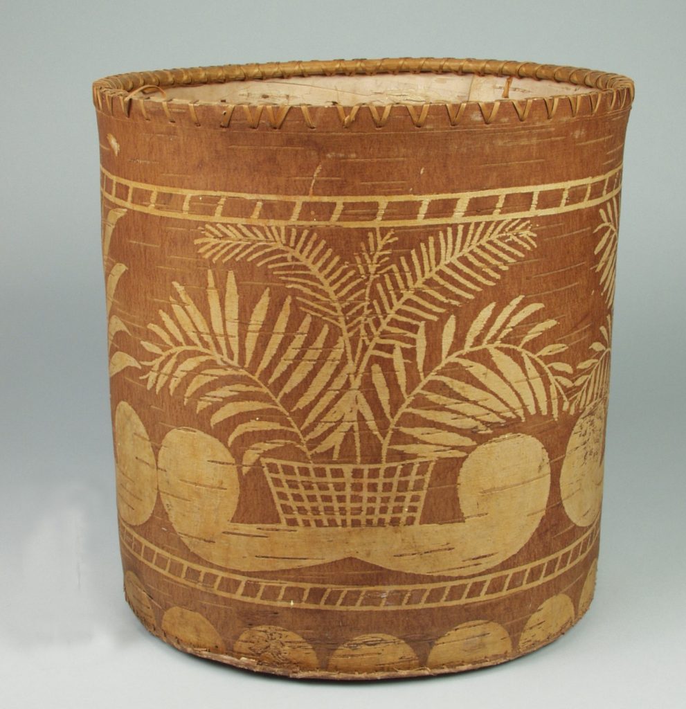 Wastebasket made of birchbark with etched designs of double curves and plants.