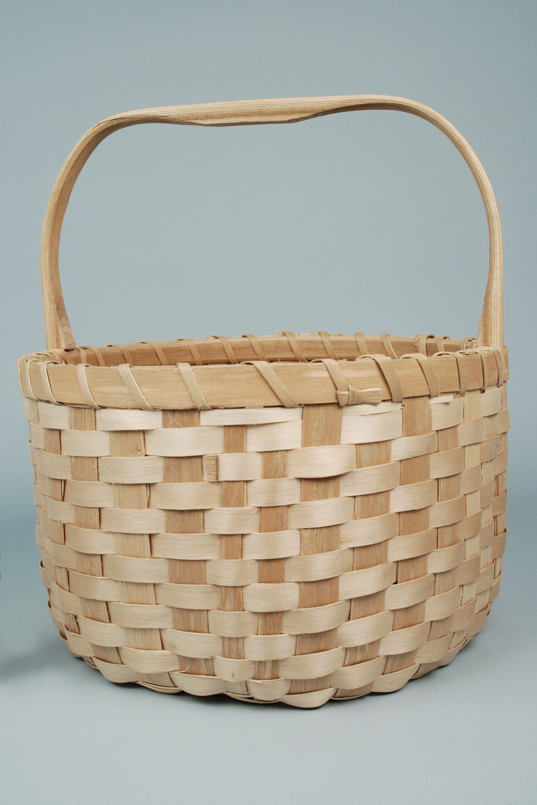 Image of a simple, sturdy basket with a handle.