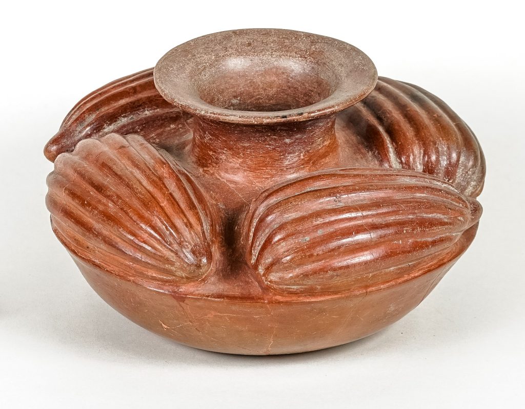 Ceramic pot with decorations shaped like cacao pods.