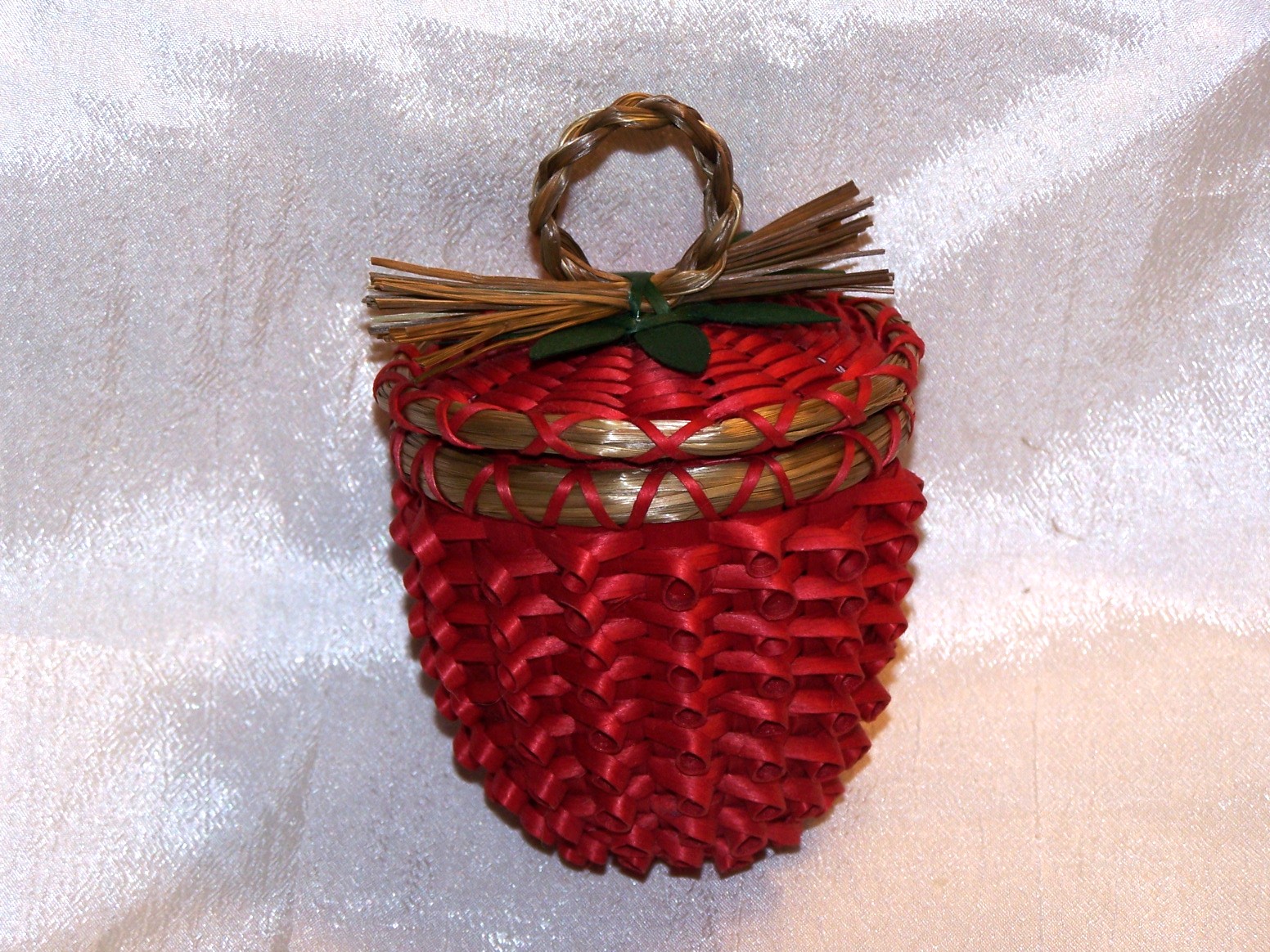 Small red basket shaped like a strawberry